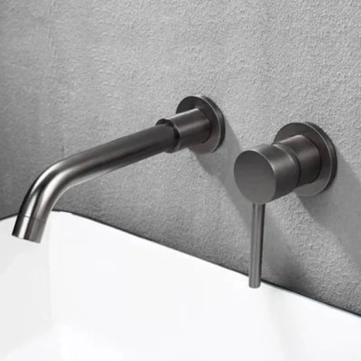 Minimalist wall-mount basin faucet set with brushed finish and single-handle design installed on a bathroom wall.