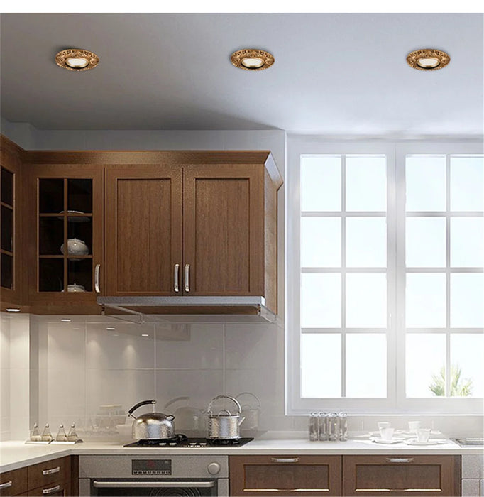 Retro cat eye LED ceiling lamps in modern kitchen setting with wooden cabinets and large window.