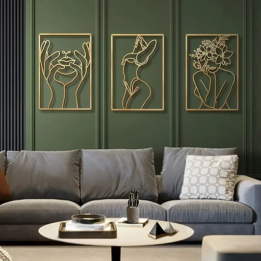 Minimalist woman silhouette line sculptures on dark wall above modern sofa in stylish living room.