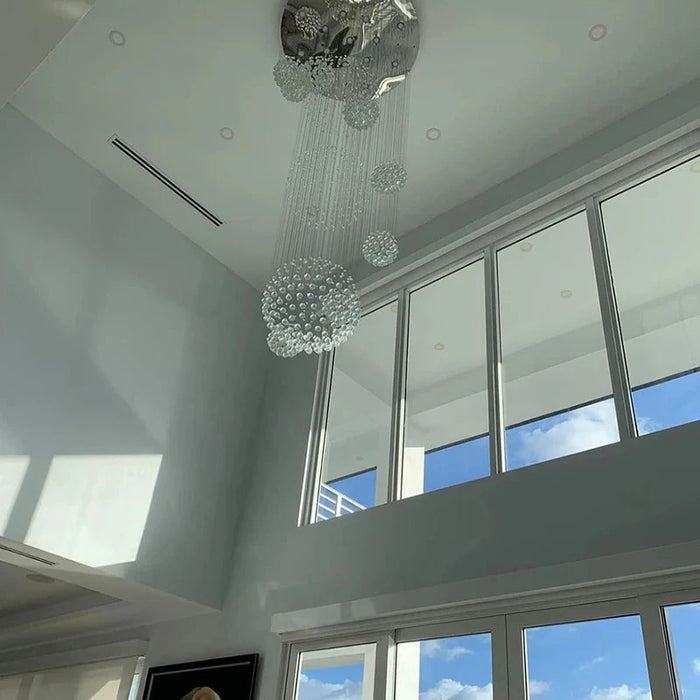 Luxury Crystal Sphere Chandelier in modern interior with high ceiling and large windows, enhancing elegance and sophistication.