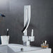 Luxury brass square basin mixer faucet on bathroom sink with sleek design and polished finish.