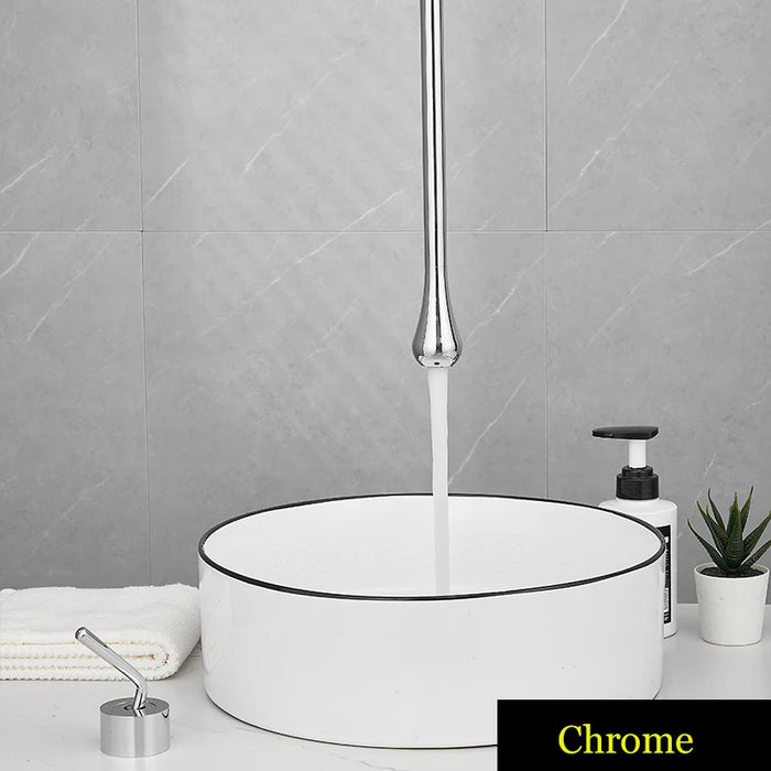 Chrome Water Drop Hang Ceiling Faucet over modern bathroom sink with towel and soap dispenser nearby.