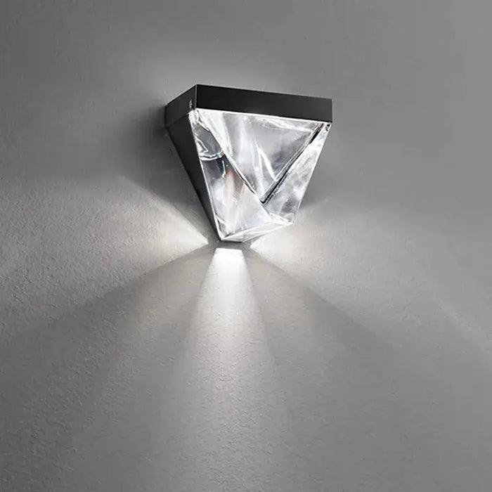 Luxury crystal wall lamp sconce with LED illumination on gray wall. Perfect for modern home decor and elegant lighting.