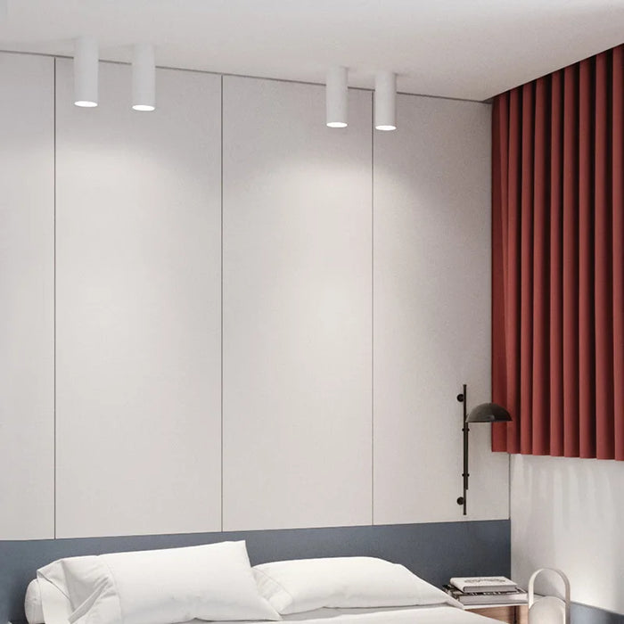 Modern bedroom with long tube LED ceiling lamps, featuring aviation-grade aluminum design and soft lighting for elegant ambiance.