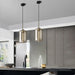 Modern industrial glass pendant lamps hanging in a sleek kitchen interior, adding elegance and ambient lighting.