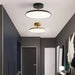 Modern rotatable LED ceiling light with minimalist design in a contemporary interior setting.