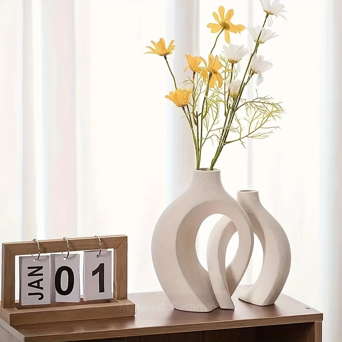 Nordic Boho Ceramic Vase Set with yellow flowers on wooden table next to calendar.