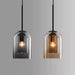 Minimalist Nordic glass pendant lights in black and amber, featuring sleek post-modern design for contemporary spaces.