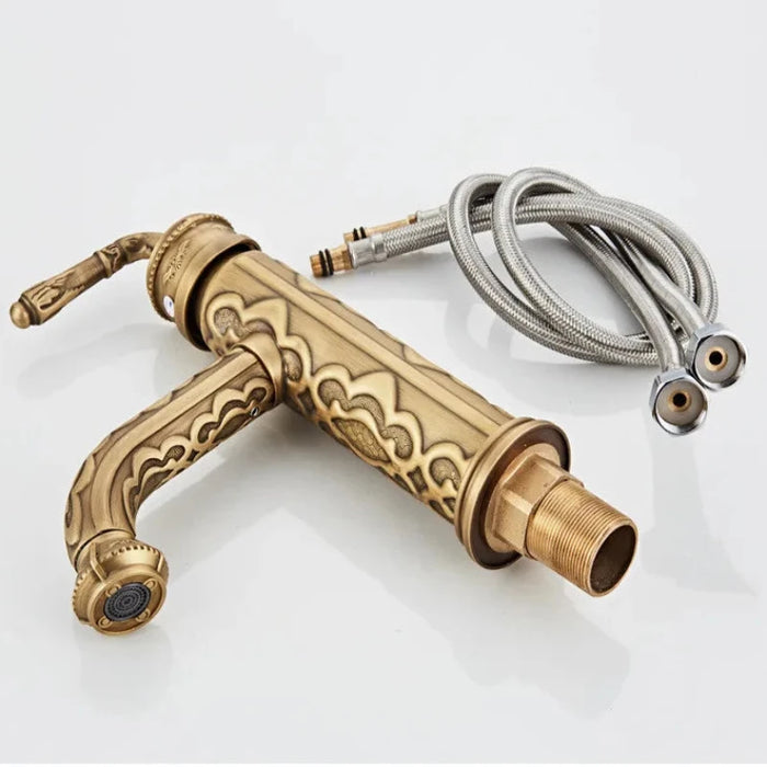 Antique brass swivel basin faucet with ornate design and attached supply lines, featuring 360-degree swivel spout.