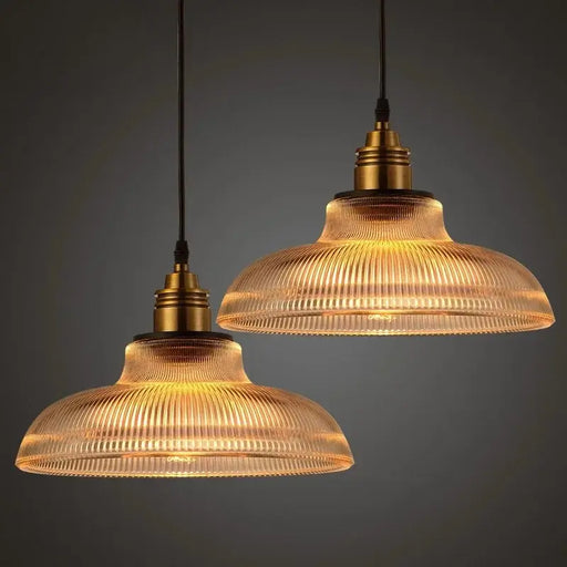 Vintage glass stripe pendant lights with textured shades casting warm ambient glow. Perfect for dining areas and kitchens.