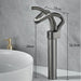 Modern brass waterfall basin faucet with single-handle design and electroplated finish next to white bathroom sink.