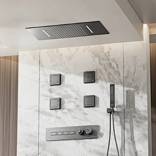 Luxury thermostatic shower system with LED display and hydrotherapy massage jets on marble wall.