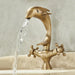 Antique brass dolphin basin faucet with unique design and water flowing effect, adding elegance to bathrooms.