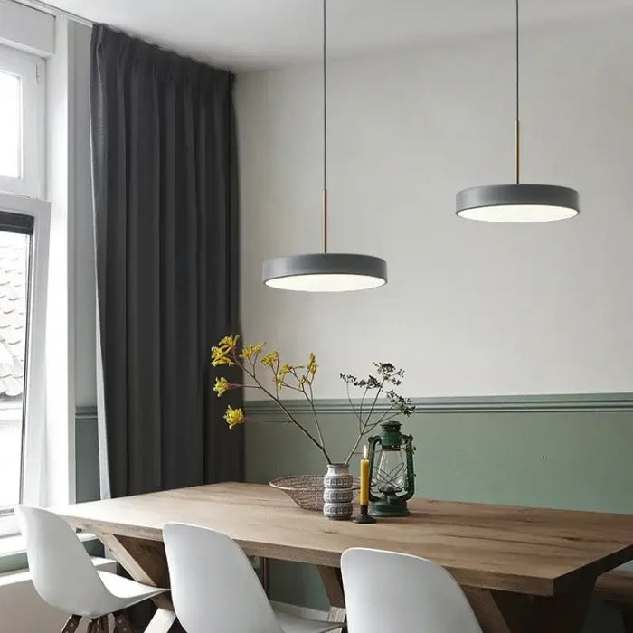 Modern LED Saucer Pendant Lights in dining room with wooden table and white chairs.