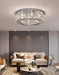 Luxury modern crystal round ceiling chandelier enhancing a sophisticated living room ambiance.