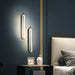 Luxurious Black & Gold LED pendant light in modern bedroom setting, showcasing sleek design and warm white illumination.