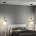 Modern bedroom with Norse LED pendant lamps illuminating a stylish interior design.