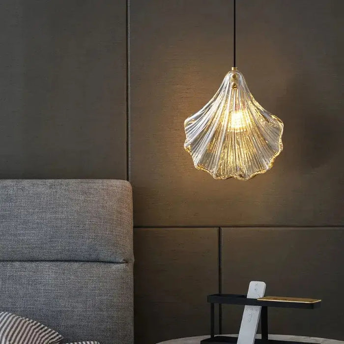 Glass shell pendant ceiling light with LED glow in a modern cozy room setting.