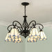 Mediterranean iron and glass LED chandelier with stained glass shades enhancing a rustic living room or bedroom ambiance.