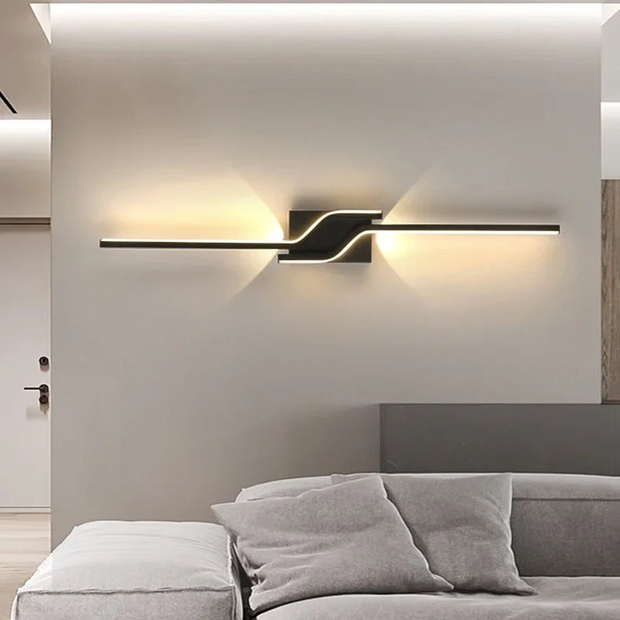 Modern minimalist LED wall sconce in a living room setting, showcasing sleek design and upward-downward light distribution.