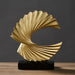 Modern spiral resin sculpture in gold finish on tabletop, abstract art decor for living room or office.