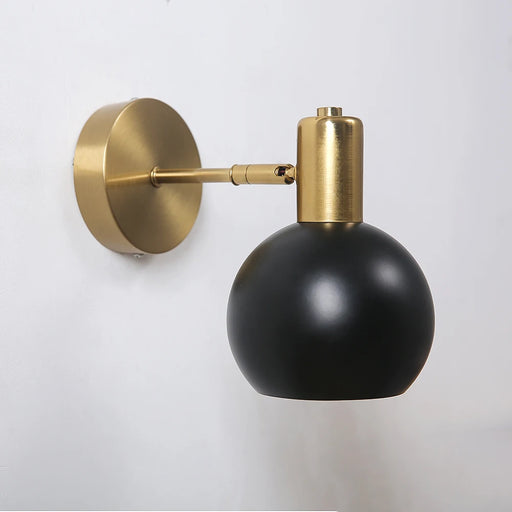 Modern adjustable LED wall lamp with long swing arm in gold and black finish, wall-mounted for elegant home lighting.