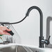 Modern black touch sensor kitchen faucet with pull-down sprayer in operation, showcasing hands-free convenience and sleek design.