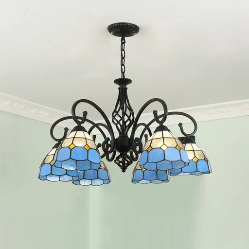 Mediterranean iron and glass LED chandelier with blue stained glass shades, enhancing room decor.