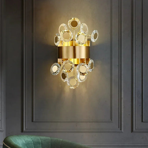 Modern luxury LED crystal wall lamp with gold accents, illuminating a sophisticated room setting.