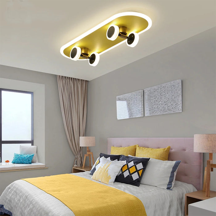 Yellow and black skateboard ceiling lamp in a modern bedroom, featuring a playful design with acrylic for gentle light diffusion.