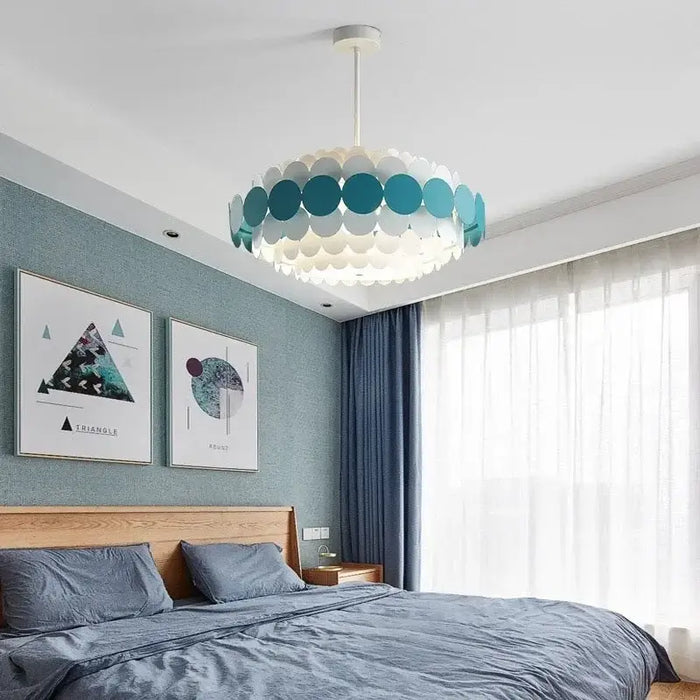 Vibrant retro circular chandelier with colorful disks in a modern bedroom, enhancing aesthetics and illumination.