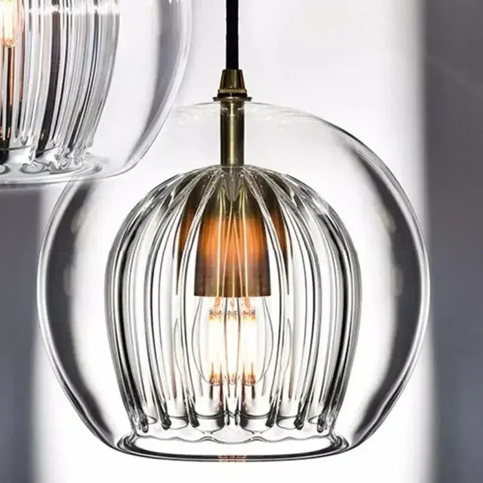 Modern glass double shade pendant light with unique design, ideal for elegant home decor, featuring layered warm lighting effect.