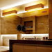 Elegant wood LED wall lamp in modern bathroom with adjustable lighting and premium wood and acrylic design.