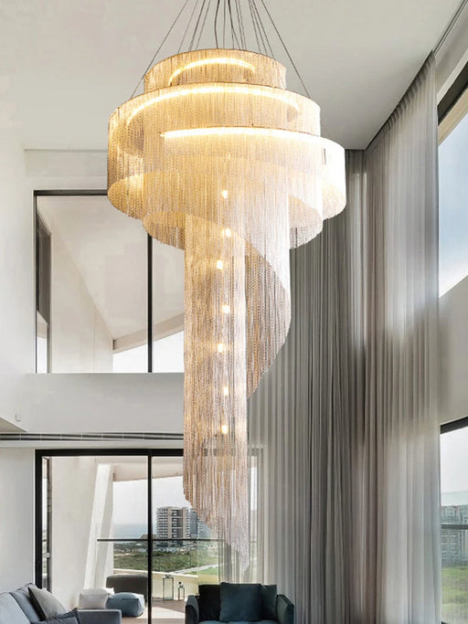 Modern Loft Spiral Chandelier with golden tassels in a spiral staircase design hanging in a luxurious living room.