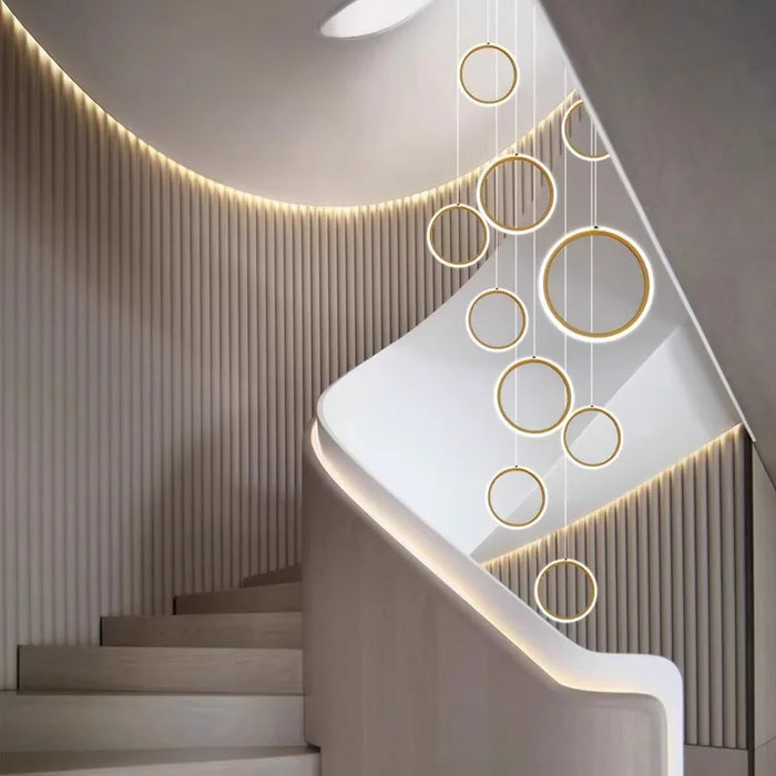 Elegant Nordic rings pendant chandelier in modern staircase with minimalist Scandinavian design elements.