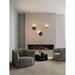 Modern artistic wall lamps in a sleek living room setting with contemporary furniture and minimalist décor.