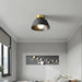 Retro iron ceiling LED light in a modern bedroom setting, vintage elegant design with perforated iron detail.