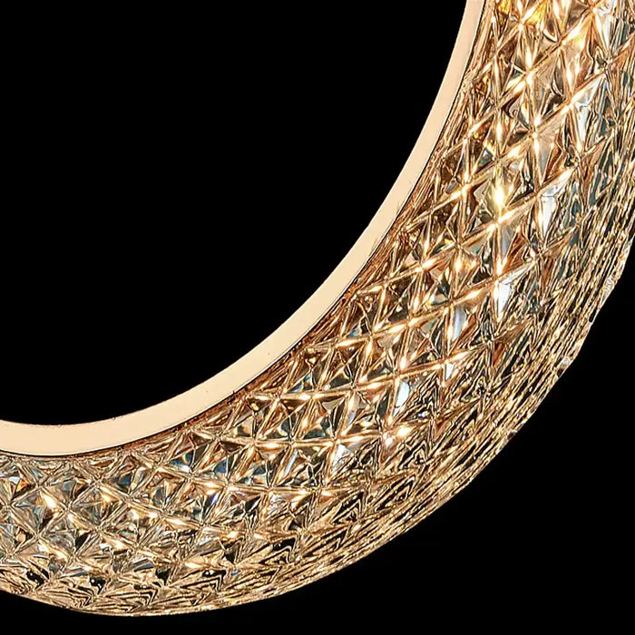 Close-up of textured crescent moon chandelier detail with golden electroplating finish, showcasing modern celestial design.