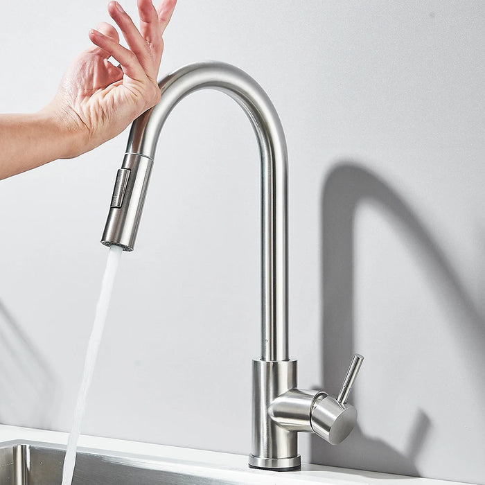 Hand using touch sensor on kitchen faucet for precise water control and modern convenience.