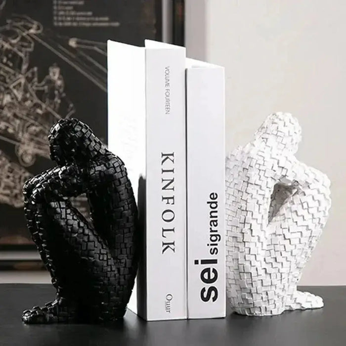 Mosaic Thinker Resin Bookends holding books, featuring black and white abstract figures with a mosaic pattern, perfect for home decor.