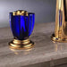 Luxury gold faucet with a vibrant blue handle on a marble countertop, highlighting modern design and elegance.