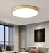 Modern round wooden LED ceiling light in stylish room with soft ambiance.