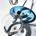 Modern Umbra Colored Glass Pendant with blue and clear orb, artistic design reflecting light and miniature goldfish imagery.