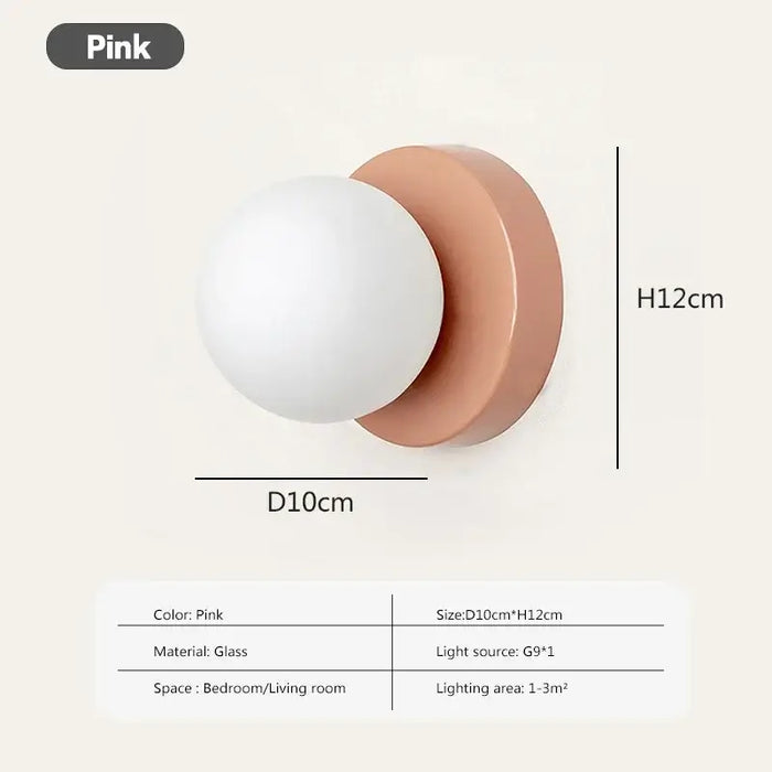 Modern LED wall sconce with frosted glass globe in pink, measures 10cm x 12cm, ideal for small spaces, G9 bulb included.