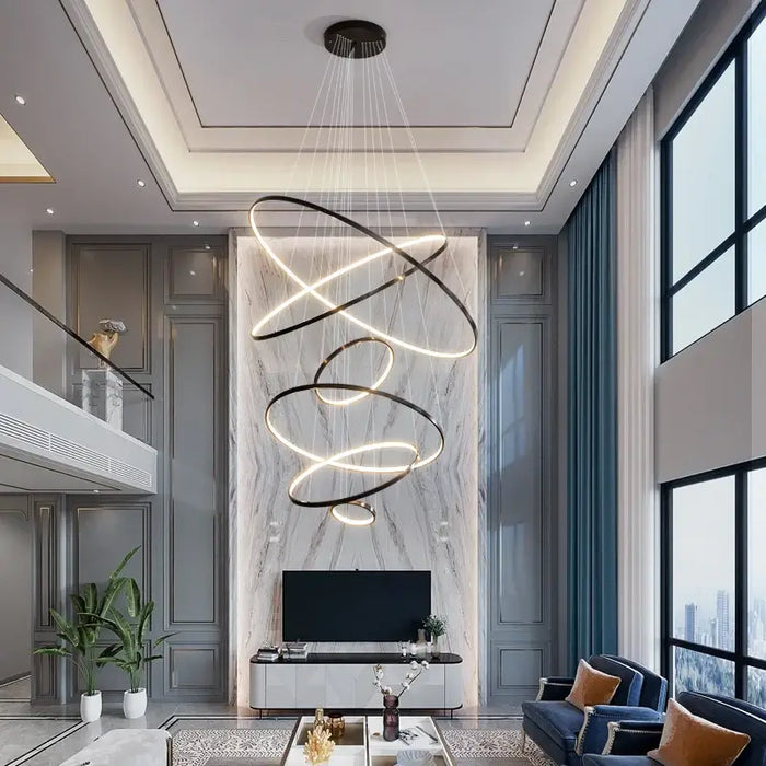 Modern LED multi-ring chandelier in elegant living room setting with high ceilings and floor-to-ceiling windows.