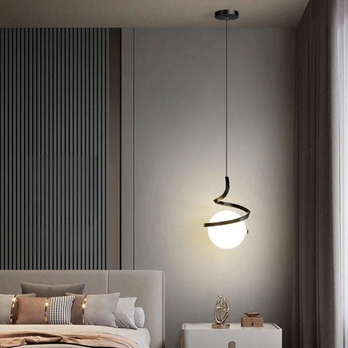 Modern Norse LED pendant lamp with glass and iron design, illuminating a stylish bedroom with switchable light colors, hanging above a side table.