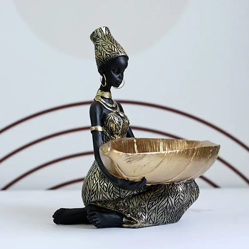 African Woman Storage Figurine with gold leaf tray, showcasing intricate leaf-patterned dress and traditional accessories.