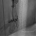 Luxury shower system with digital display and waterfall outlet in polished brass finish, featuring thermostatic control.