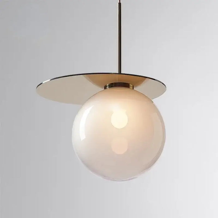 Modern Umbra colored glass pendant lamp with spherical design and soft glow, perfect for stylish home decor lighting.