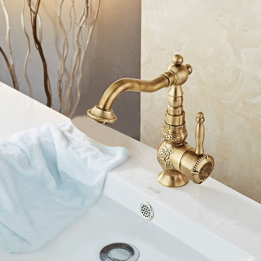 Vintage brass single handle basin faucet with elegant design on white sink in bathroom.